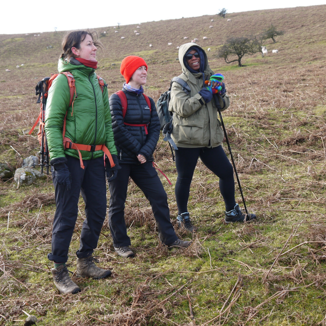 hiking for self care - three hikers standing together smiling on Dartmoor