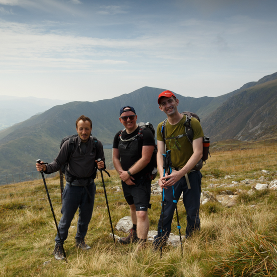 3 men hiking on wellbeing walk with Mind Over Mountains wellbeing charity