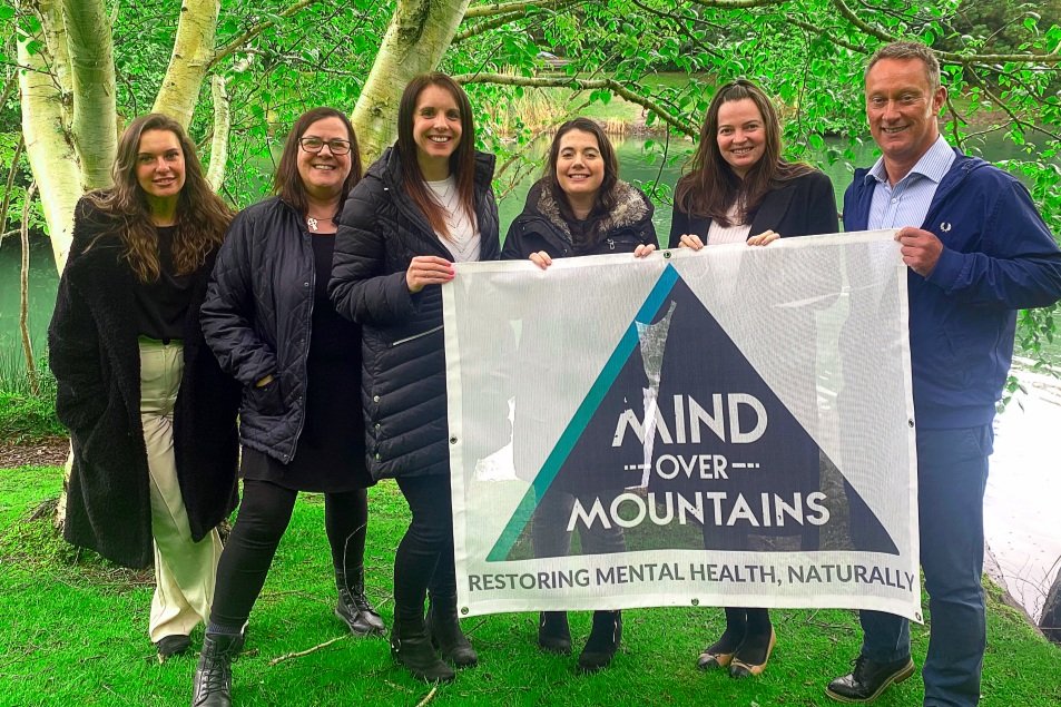 Charity patrons Westgrove Ltd supporting Mind Over Mountains - group with logo banner