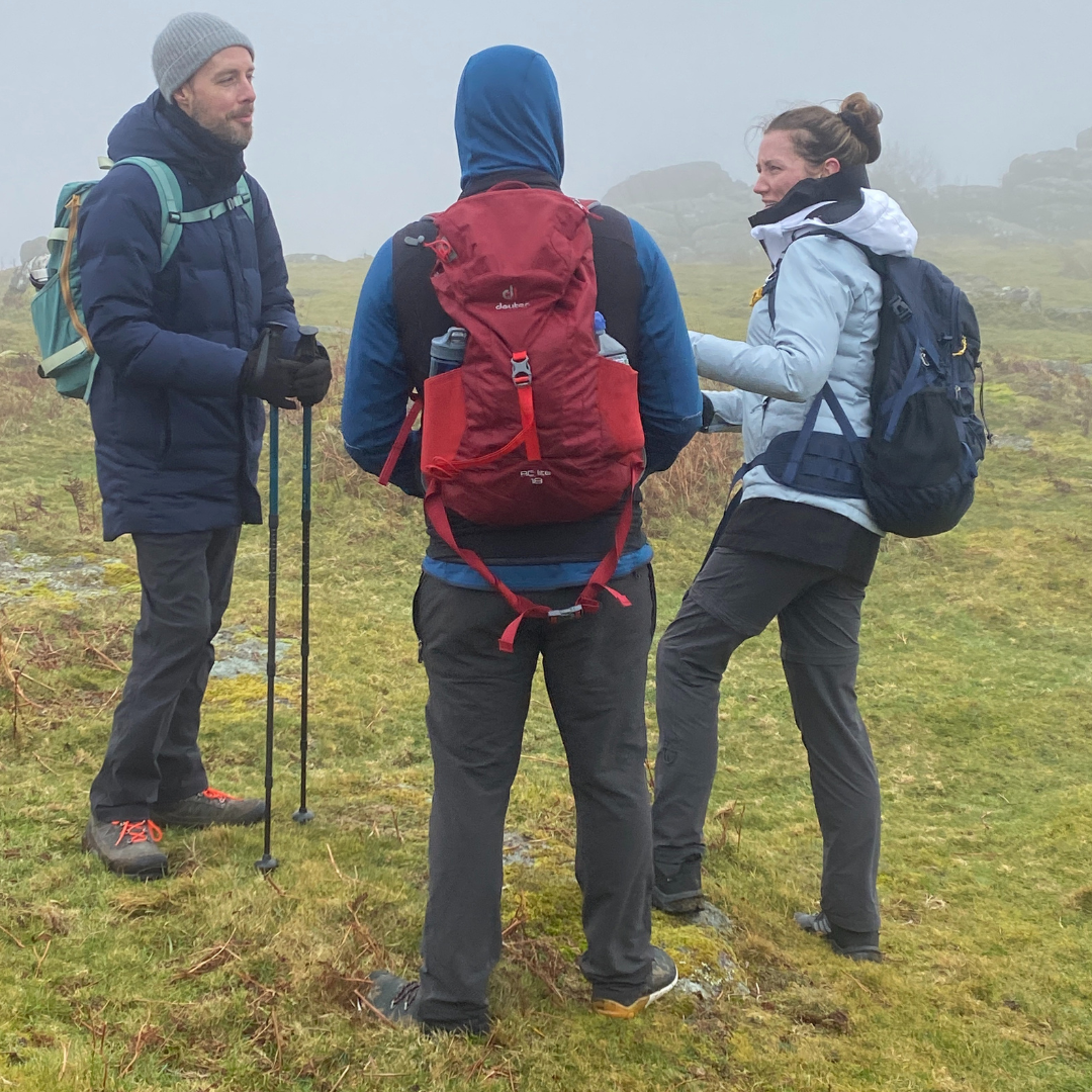 group of three hikers taking part in mental wellbeing retreat Dartmoor with Mind Over Mountains