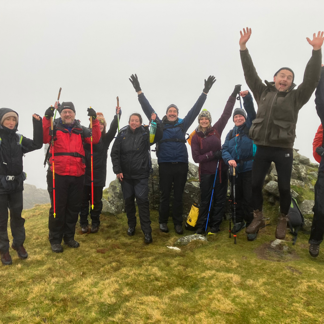 retreat hikers group celebrating reaching the summit in foggy weather on Mind Over Mountains hiking and wellbeing retreat at Wasdale Hall Lake District 