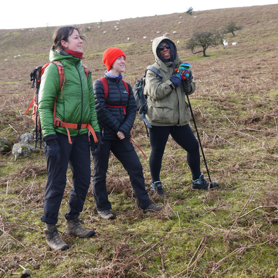 hiking for self care - three hikers standing together smiling on Dartmoor