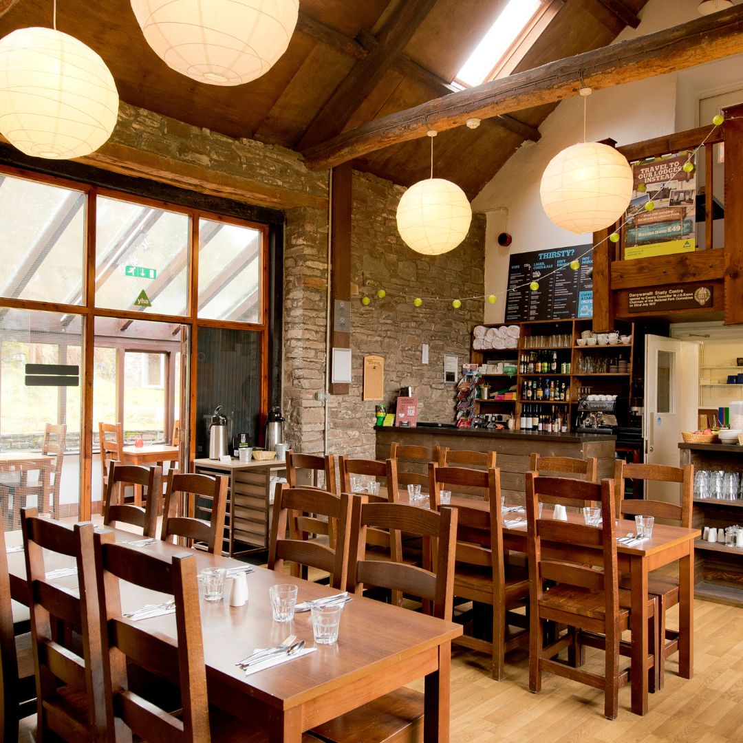 Dining area with wooden tables and chairs in a restaurant setting.