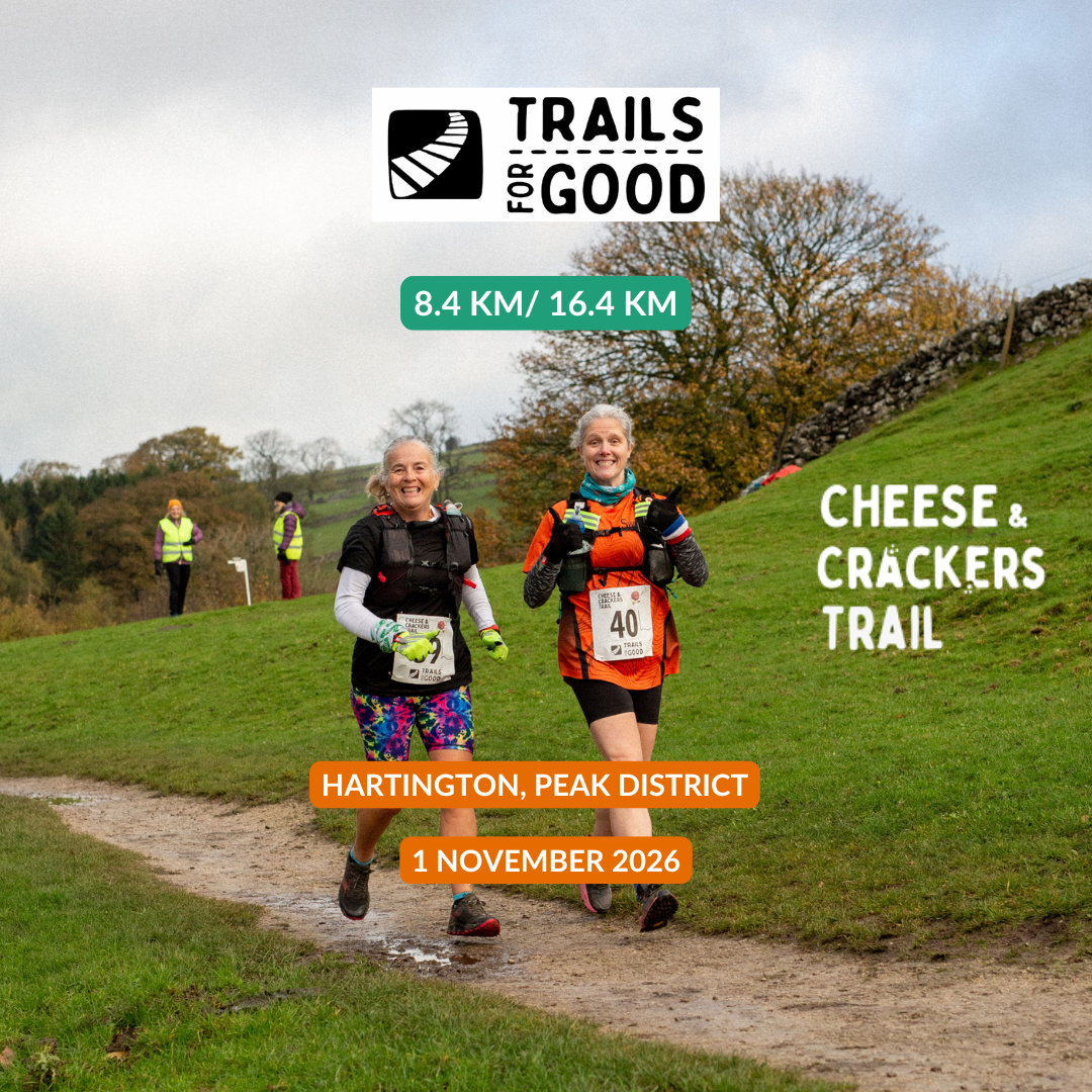 Promotional graphic for the Trails for Good 2026 'Cheese & Crackers' trail race, showing two female runners on a grassy path in Hartington, Peak District. The graphic includes text overlays with race details: '8.