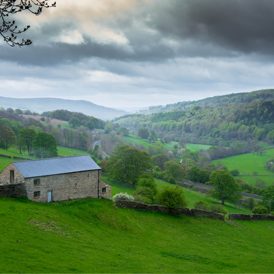 Hathersage view with green hills and barn