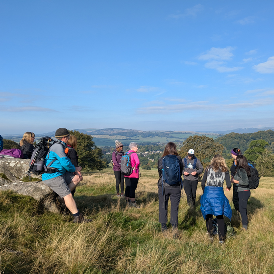 Group of hikers chatting on peak district mountainside