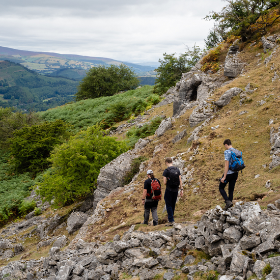 group of 3 people hiking on rocky path Denbighshire North Wales