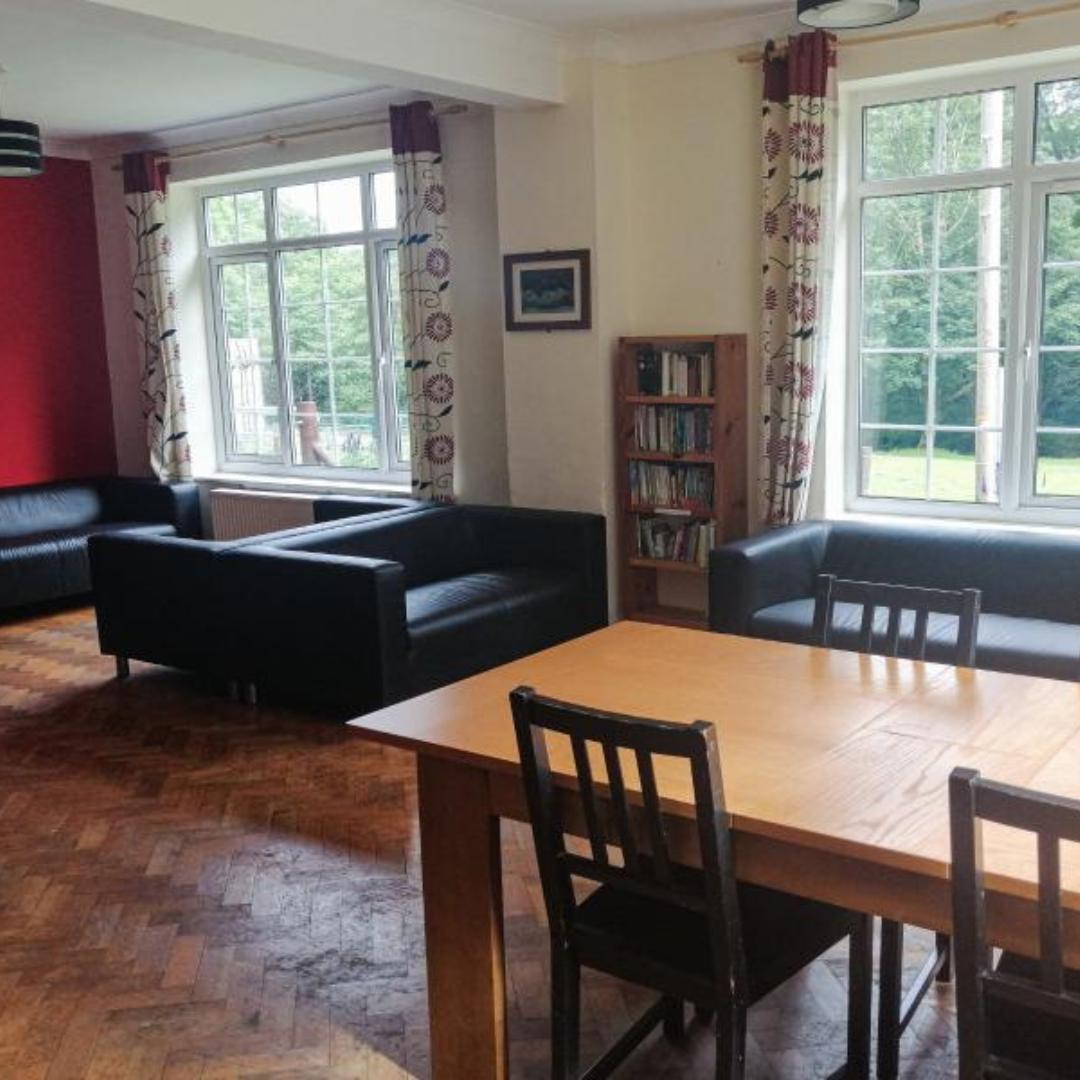 interrior at Kings youth hostel showing tables, chairs, bookshelf and sofas