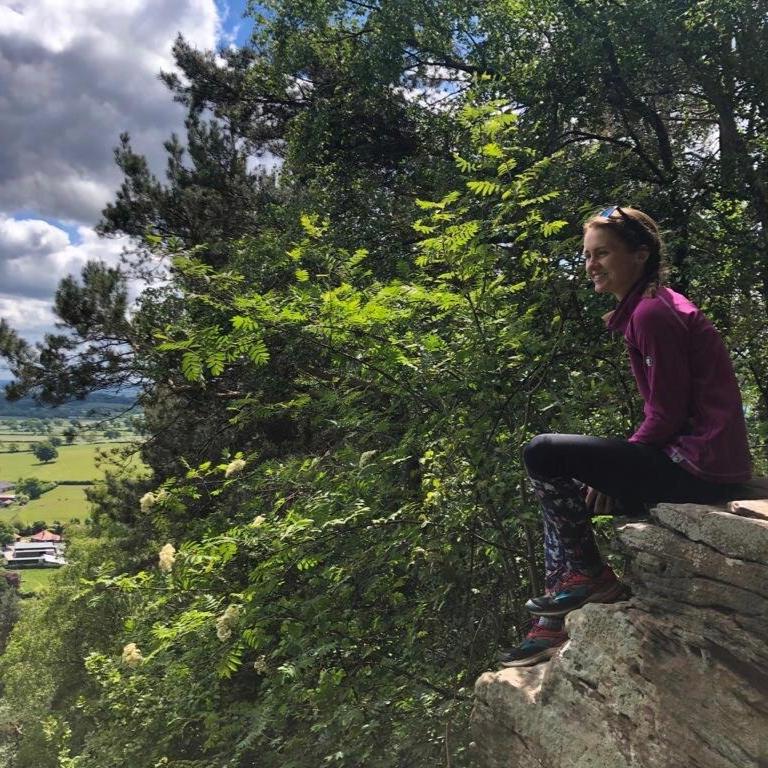 woman out hiking with trees