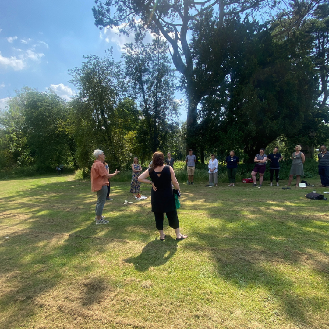 drift coaching session outdoors - group of people outdoors under tree learning about mindfulness at nature therapy NatureMind event
