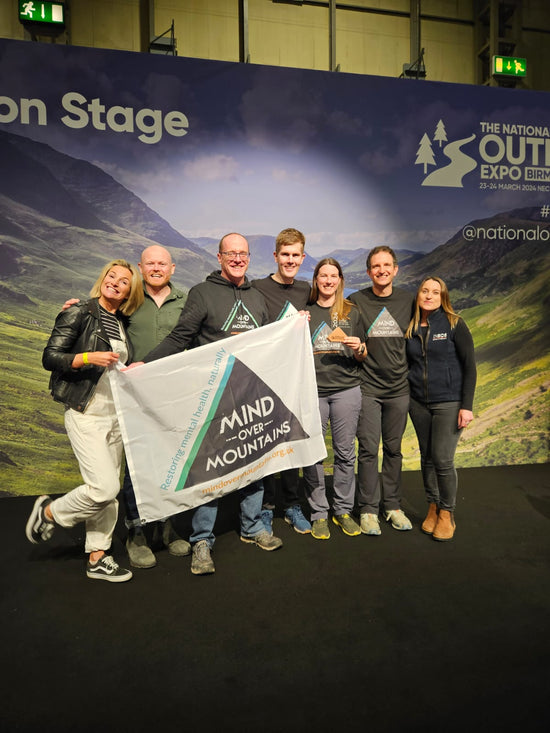 Mind Over Mountains team accepting charity award at National outdoor show
