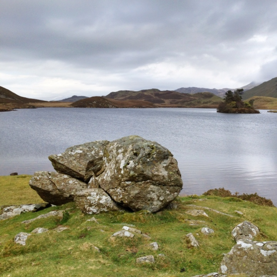 rock on shoreline of lake in Welsh mountains Eryri